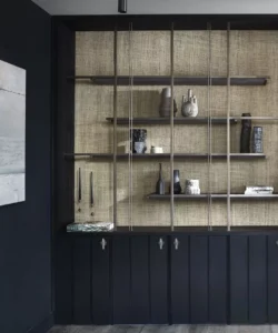 Wooden sideboard on a wooden floor, dark mat and dim walls.